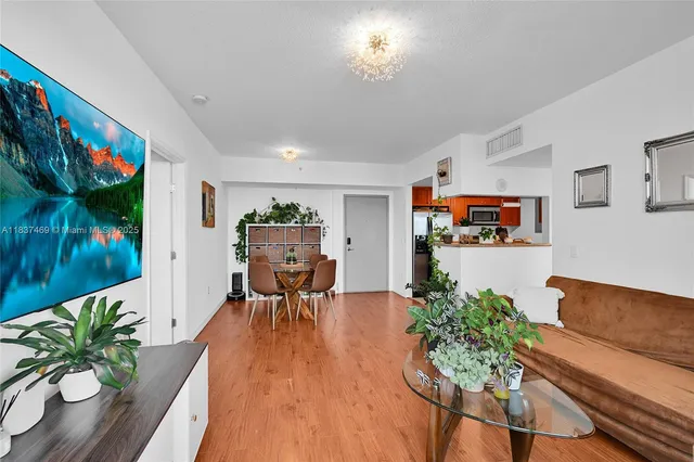 a dining room with furniture and wooden floor