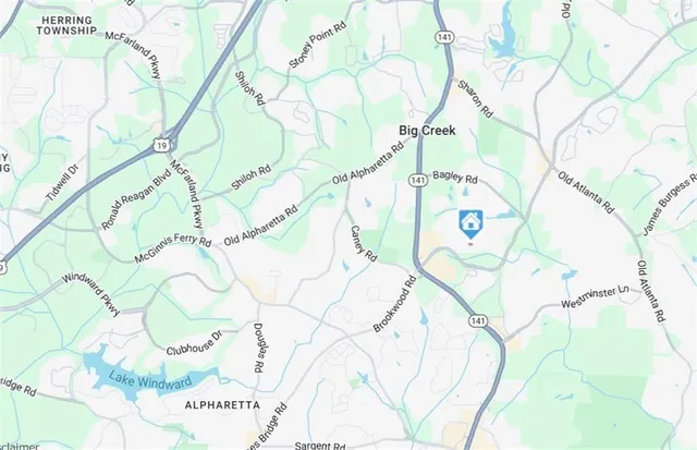 a white house with a white and a tree in the background