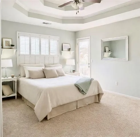 a spacious bedroom with a bed and a couch