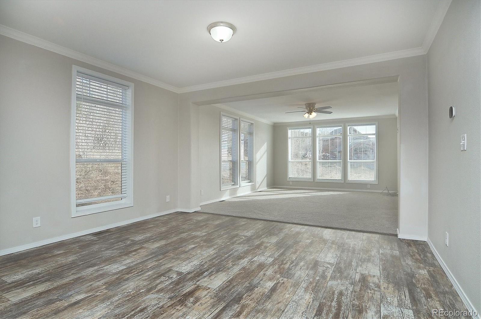 16554 Rocky Mountain Road Salida, CO 81201 - Photo 13 of 33 a view of an empty room with wooden floor and a window
