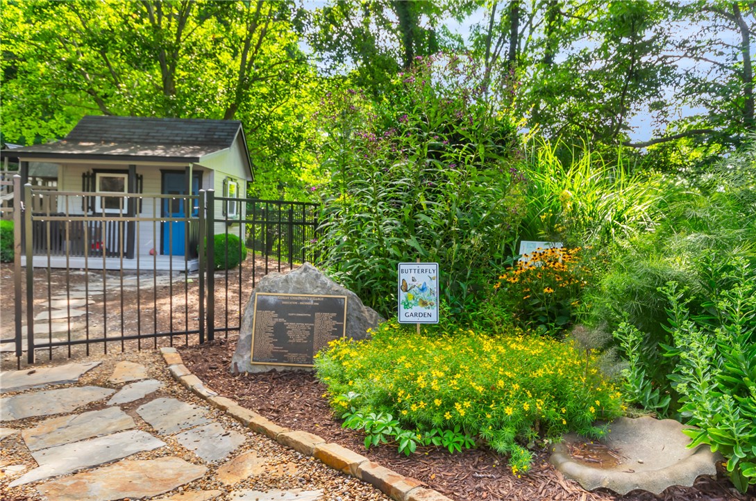 116 Witch Hazel Trail Landrum, SC 29356 - Photo 22 of 26 A well-maintained garden with a small playhouse is perfect for your children or grandchildren.
