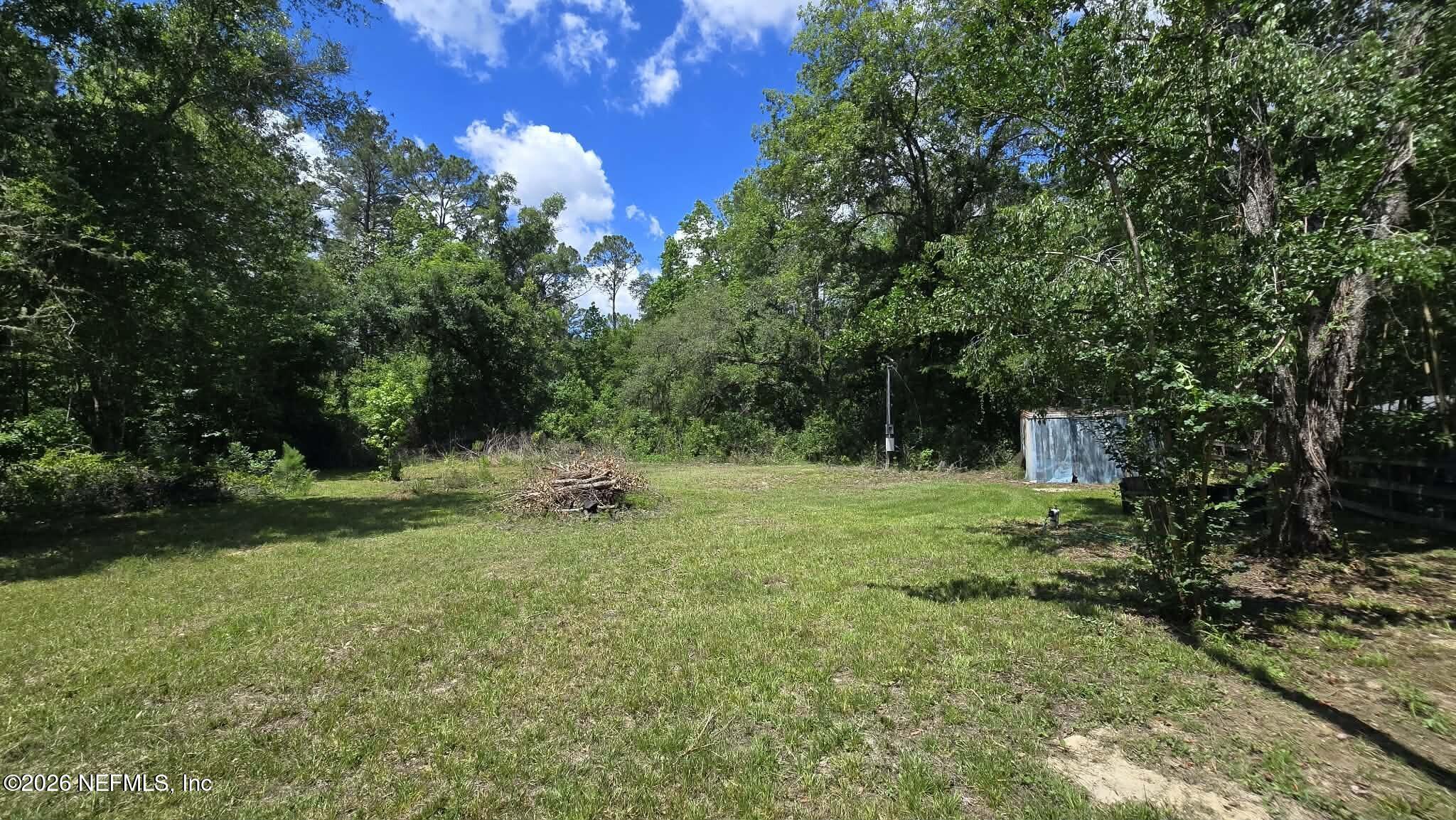 3923 Skipper Road Middleburg, FL 32068 - Photo 15 of 25 a backyard of a house with a yard and outdoor seating