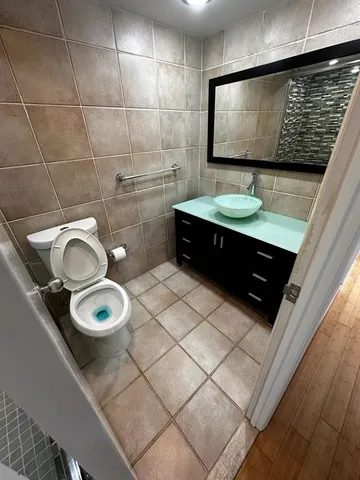 a bathroom with a toilet sink and mirror