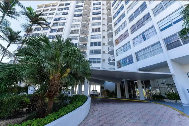 a view of building with yard and plants