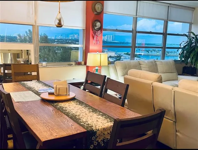 a living room with furniture and a floor to ceiling window