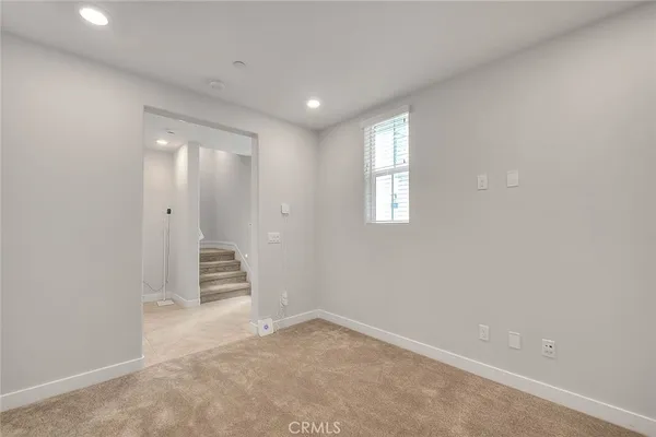 a large kitchen with granite countertop a stove top oven a sink and white cabinets