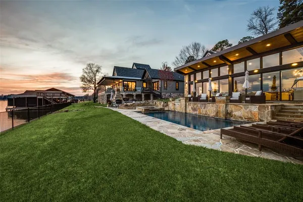 a view of a swimming pool with a garden and plants
