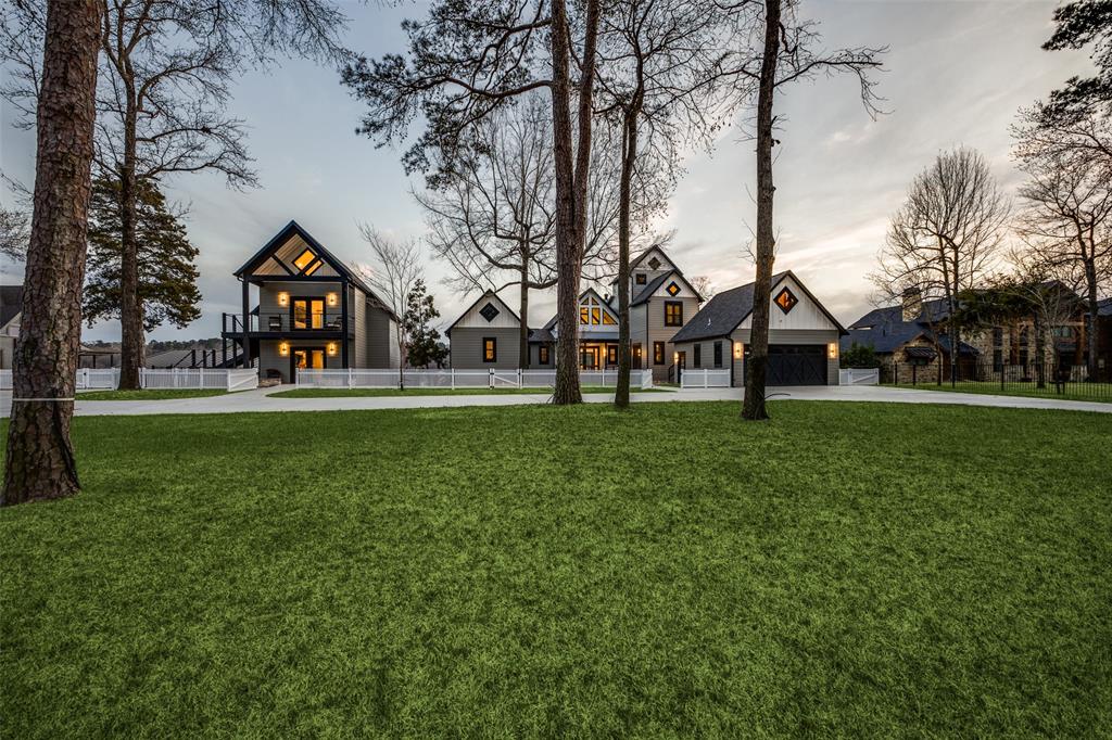 260 Cypress Marina Road Scroggins, TX 75480 - Photo 5 of 40 a view of a white house with a big yard and large trees