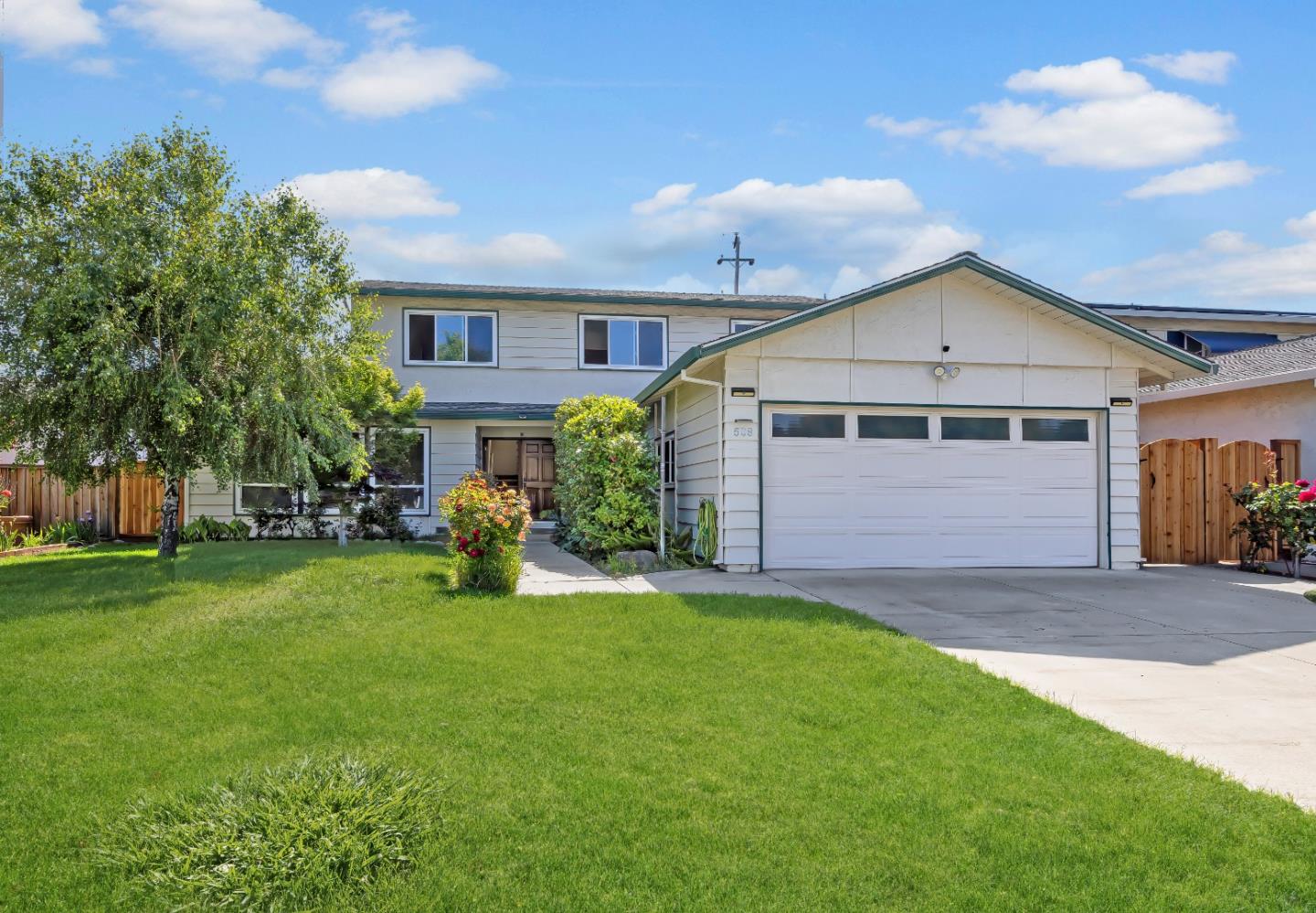 a view of a house with a yard and sitting area