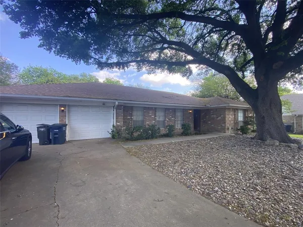 a view of a house with a tree in the background