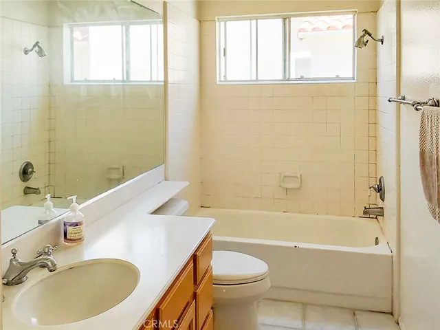 a view of a patio with a table and chairs under an umbrella