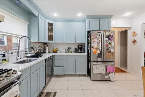 a kitchen with stainless steel appliances granite countertop a refrigerator and a sink