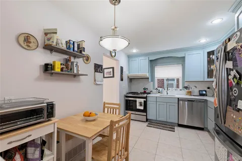 a kitchen with stainless steel appliances granite countertop a stove and a refrigerator
