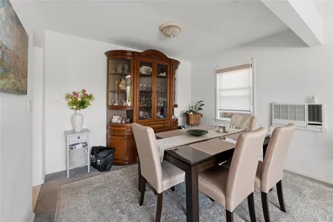 a view of a dining room with furniture and window