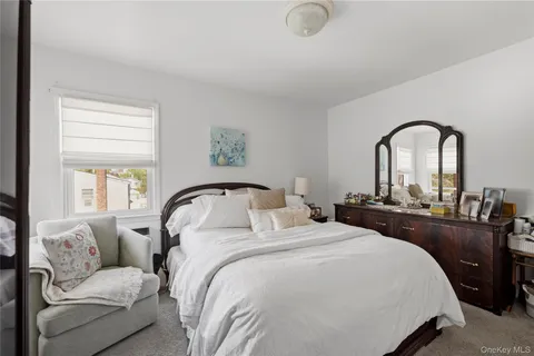 a bedroom with bed and a large window