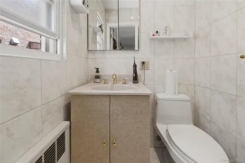 a bathroom with a sink a toilet and vanity