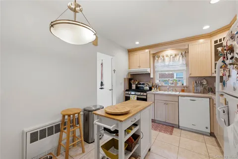 a kitchen with stainless steel appliances granite countertop a stove a sink dishwasher and a refrigerator