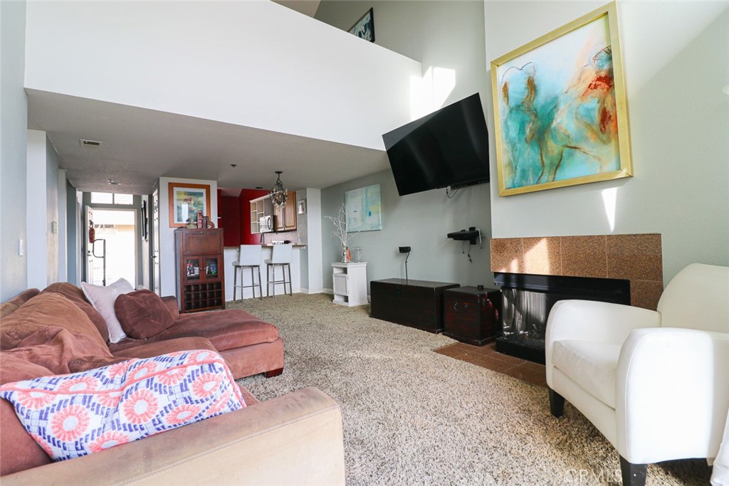 20331 Bluffside Circle, Unit 417 Huntington Beach, CA 92646 - Photo 1 of 32 a living room with furniture and a flat screen tv