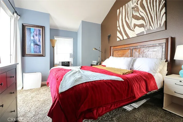 a bedroom with a bed and window