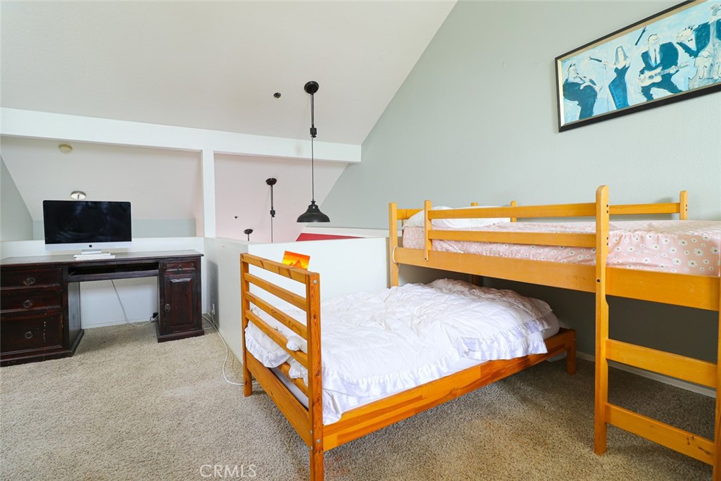 20331 Bluffside Circle, Unit 417 Huntington Beach, CA 92646 - Photo 14 of 32 a bed room with a bed and a television