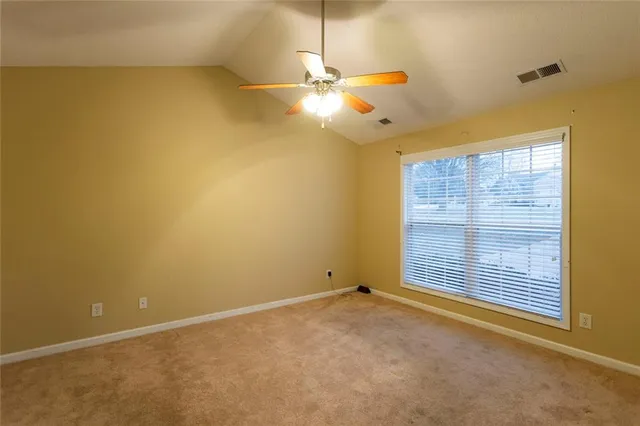 a view of a room with a window and ceiling fan