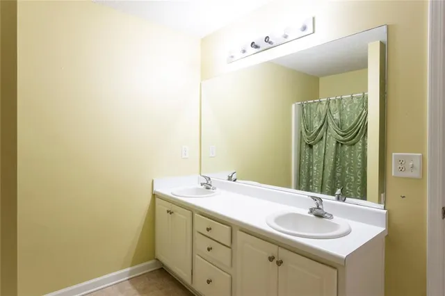 a bathroom with a double vanity sink and a mirror