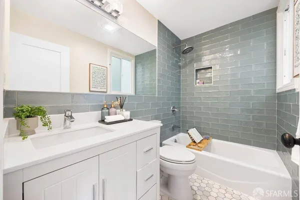 a bathroom with a sink a toilet and bathtub