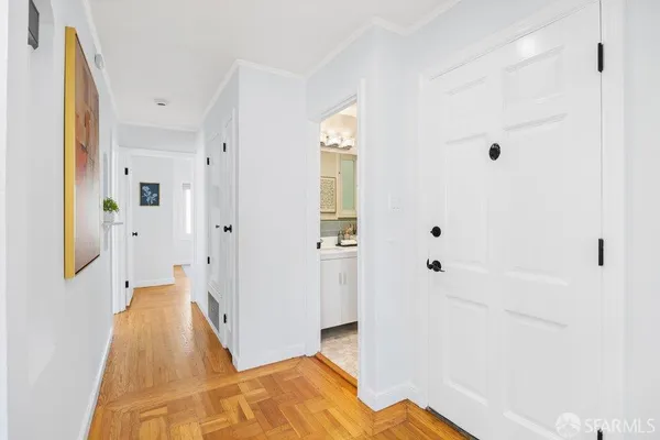 a view of a bedroom with wooden floor and bathroom
