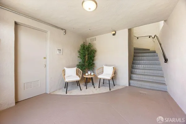 a view of a livingroom with furniture and stairs