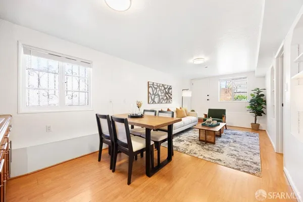 a dining room with furniture a rug and wooden floor