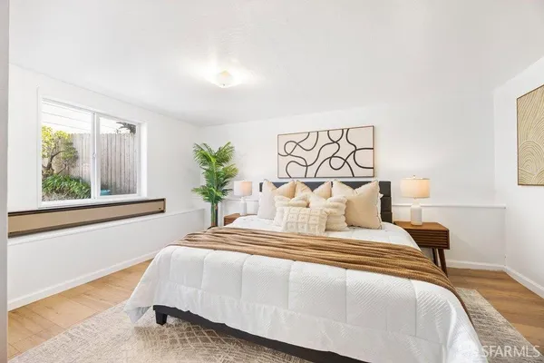a bedroom with a bed and a window