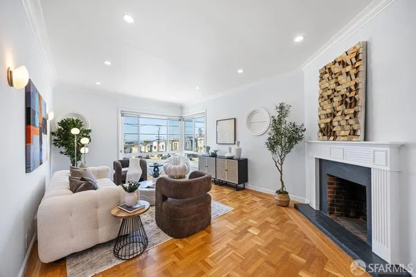 a living room with furniture a fireplace and a potted plant