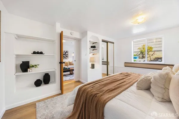 a bedroom with a large bed and a window