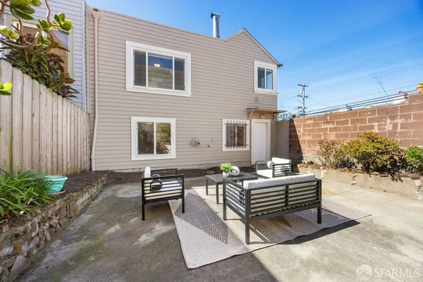 a building outdoor space with patio furniture and potted plants
