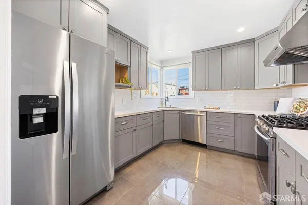 a kitchen with a refrigerator sink and stove