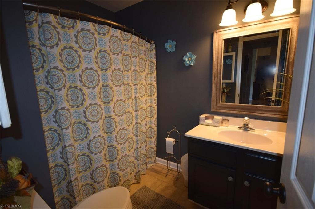 4596 Reid Road Elon, NC 27244 - Photo 14 of 21 Guest bath, with tub/shower, tile floors