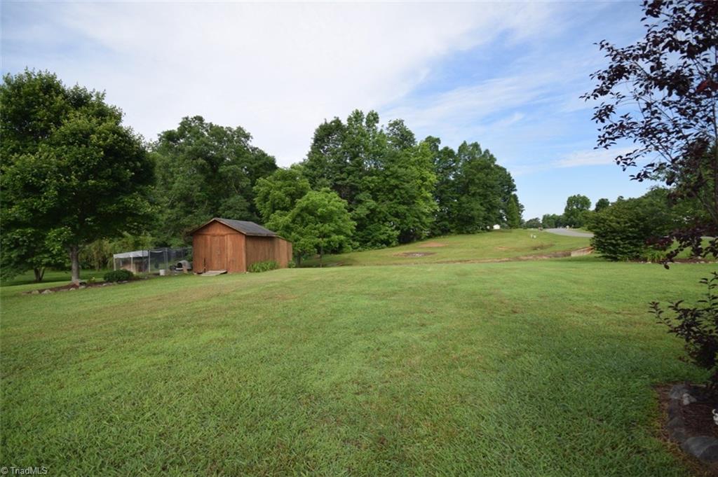 4596 Reid Road Elon, NC 27244 - Photo 3 of 21 over 1 acre lot, storage building, mature yard