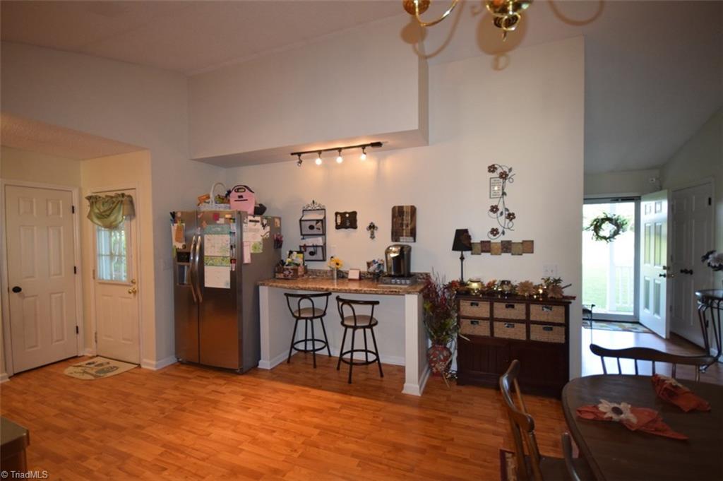 4596 Reid Road Elon, NC 27244 - Photo 6 of 21 open kitchen, pantry, bar seating, vaulted ceiling, lots of light