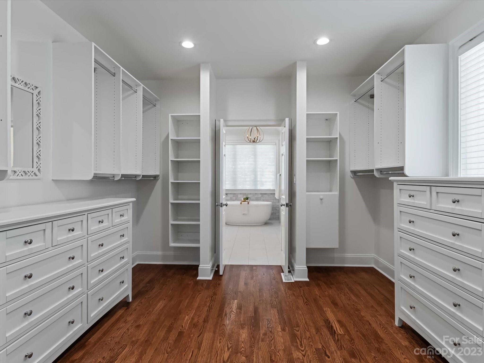 18916 Riverwind Lane Davidson, NC 28036 - Photo 13 of 25 a view of walk in closet with wooden floor