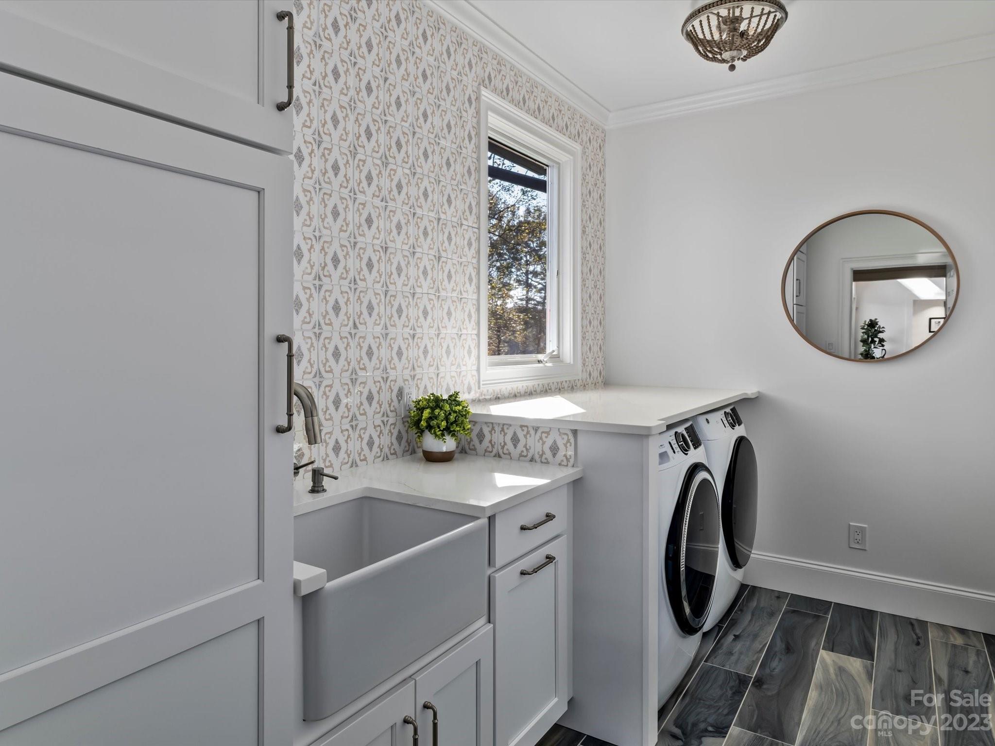 18916 Riverwind Lane Davidson, NC 28036 - Photo 16 of 25 a bathroom with a sink a washer and dryer