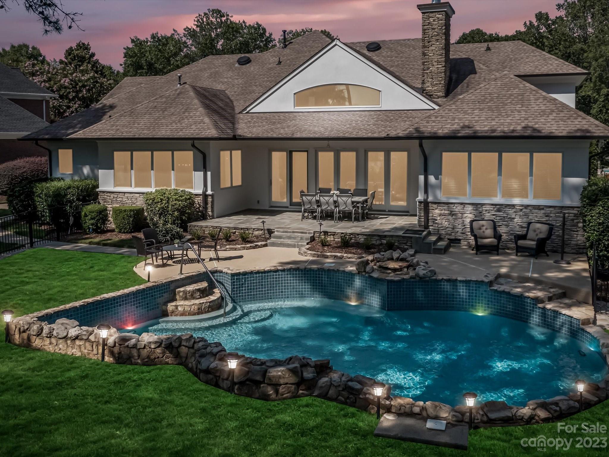 18916 Riverwind Lane Davidson, NC 28036 - Photo 18 of 25 a view of a house with backyard swimming pool and sitting area