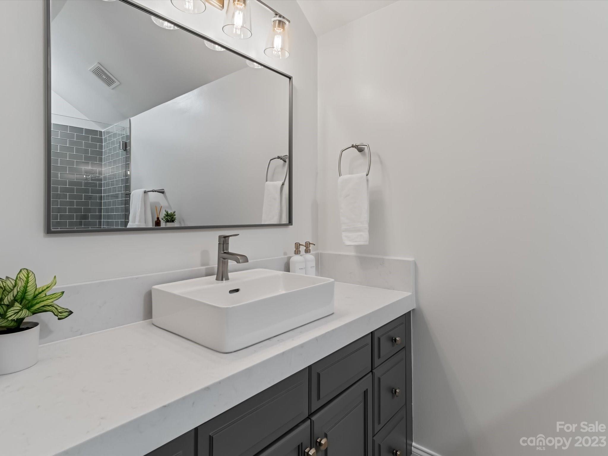 18916 Riverwind Lane Davidson, NC 28036 - Photo 20 of 25 a bathroom with a sink and a mirror