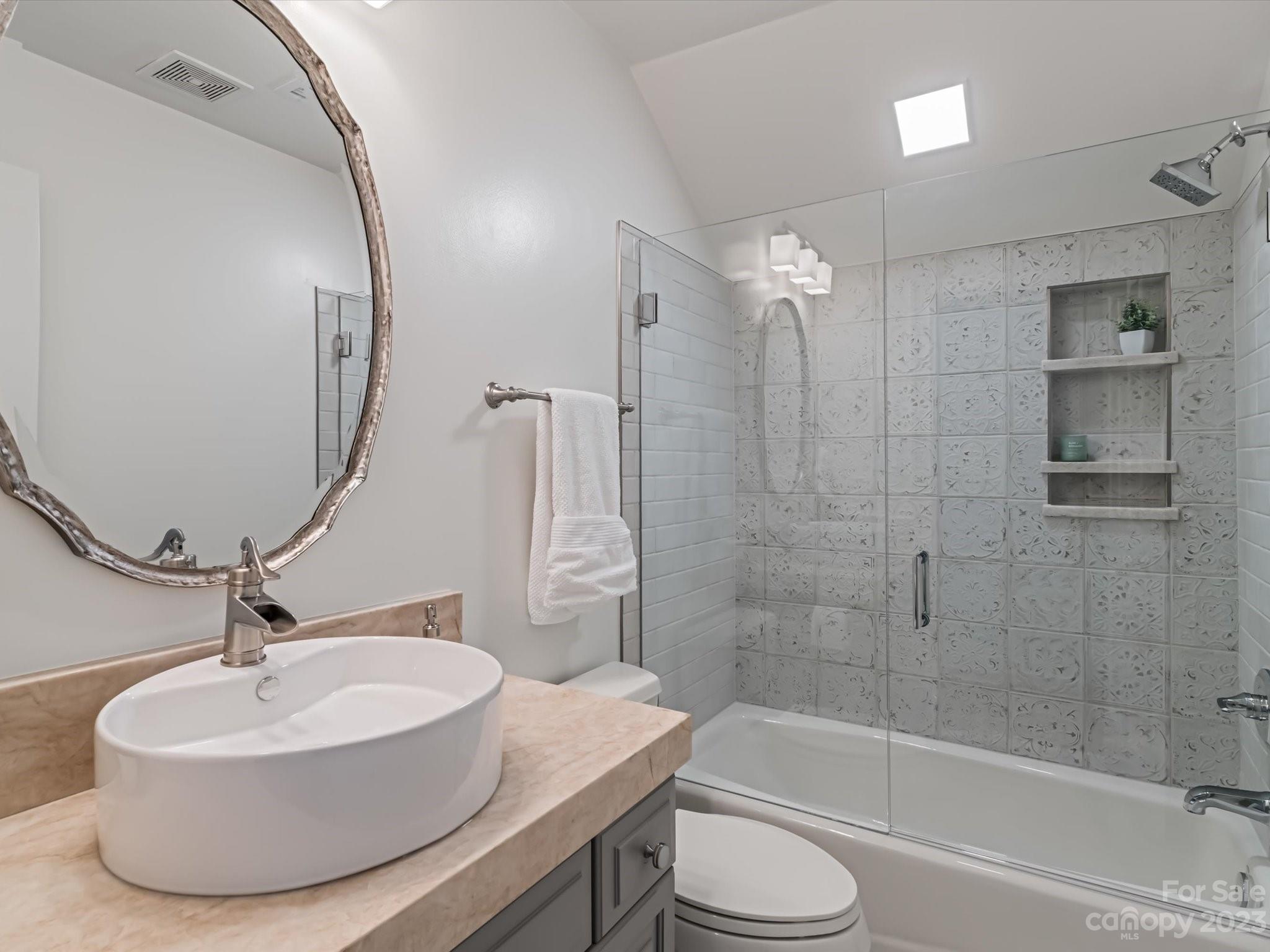 18916 Riverwind Lane Davidson, NC 28036 - Photo 21 of 25 a bathroom with a sink toilet and shower