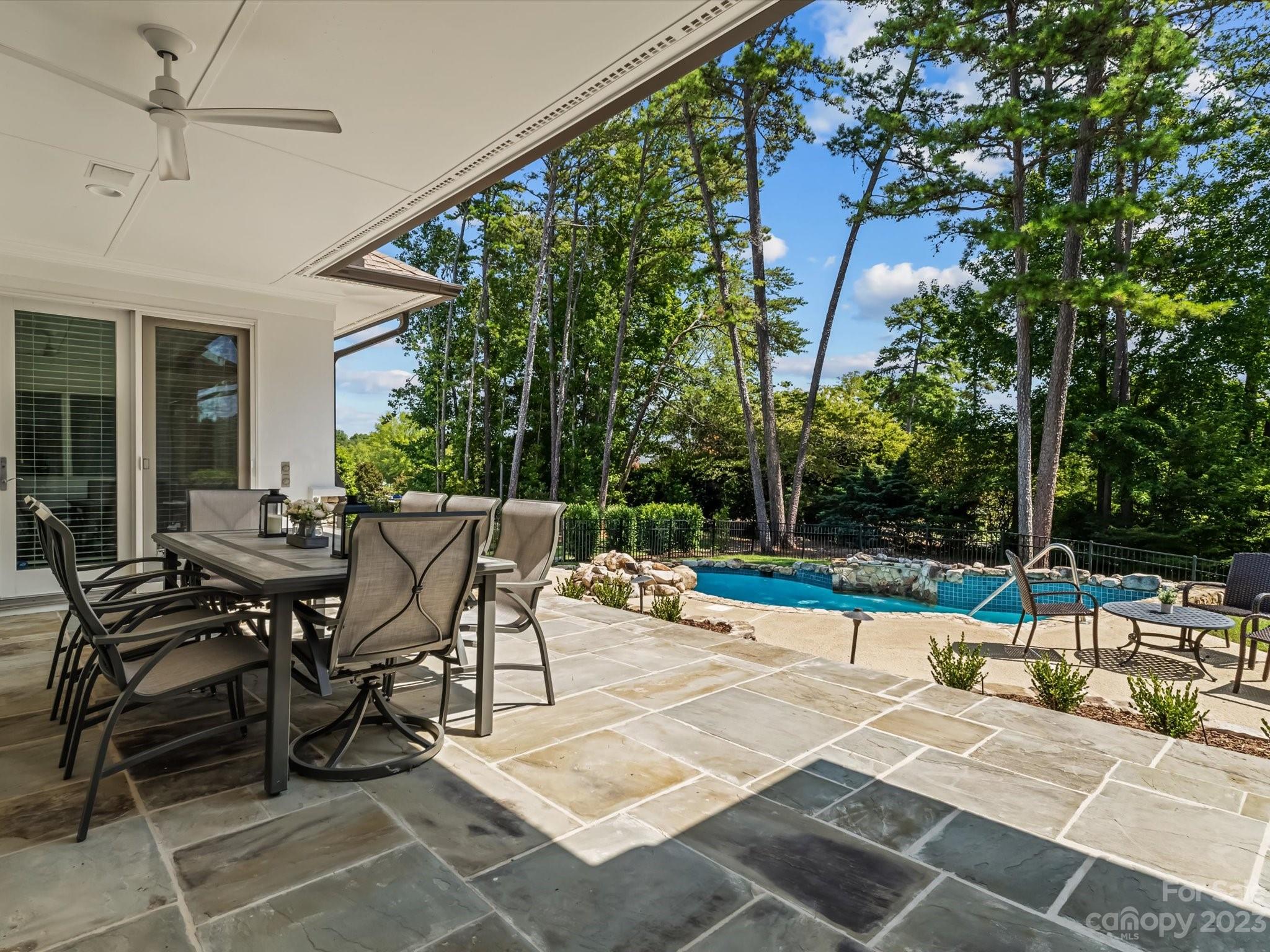 18916 Riverwind Lane Davidson, NC 28036 - Photo 22 of 25 a view of a patio with dining table and chairs with wooden floor and fence