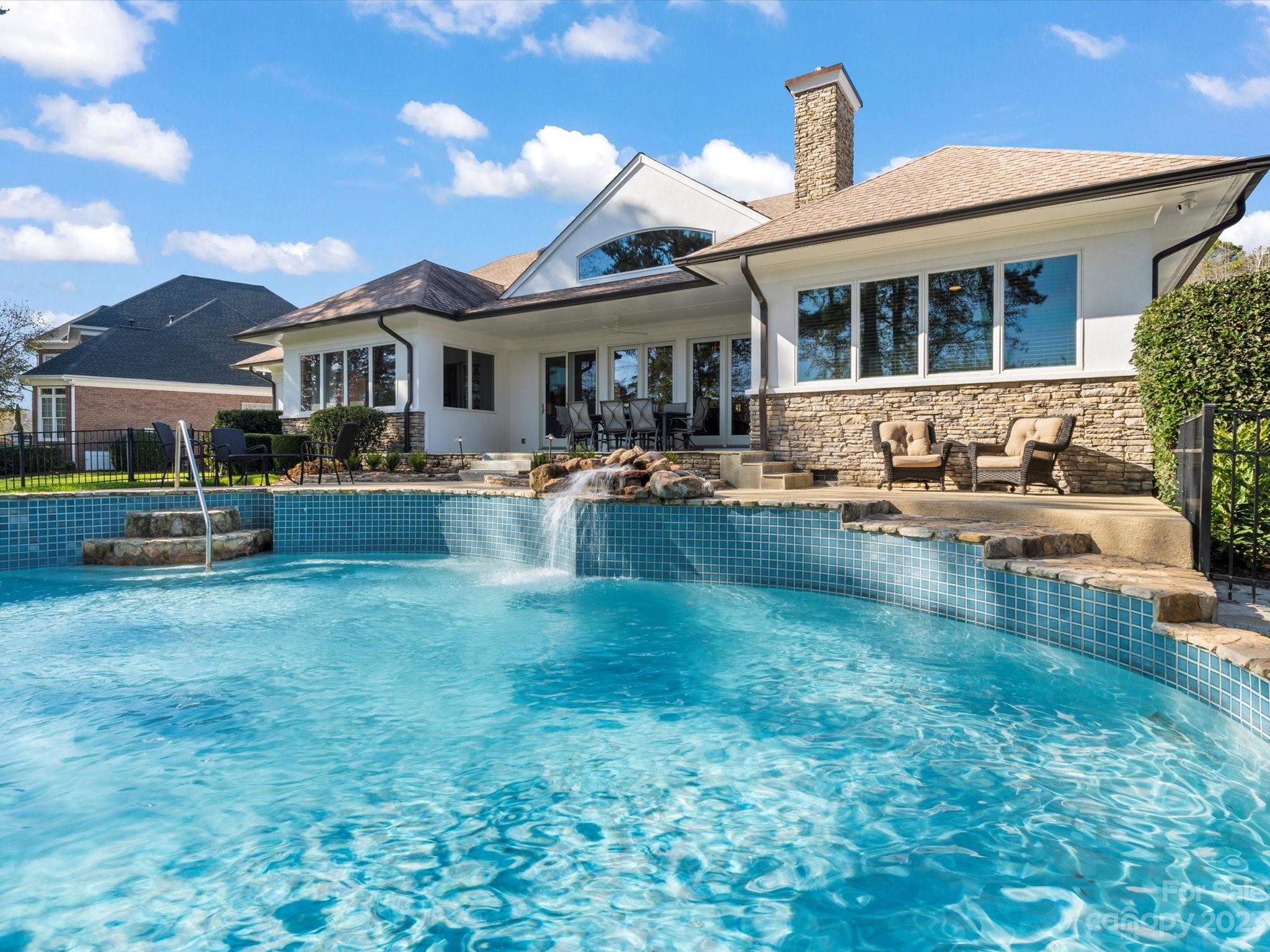 18916 Riverwind Lane Davidson, NC 28036 - Photo 23 of 25 a front view of a house with a yard table and chairs