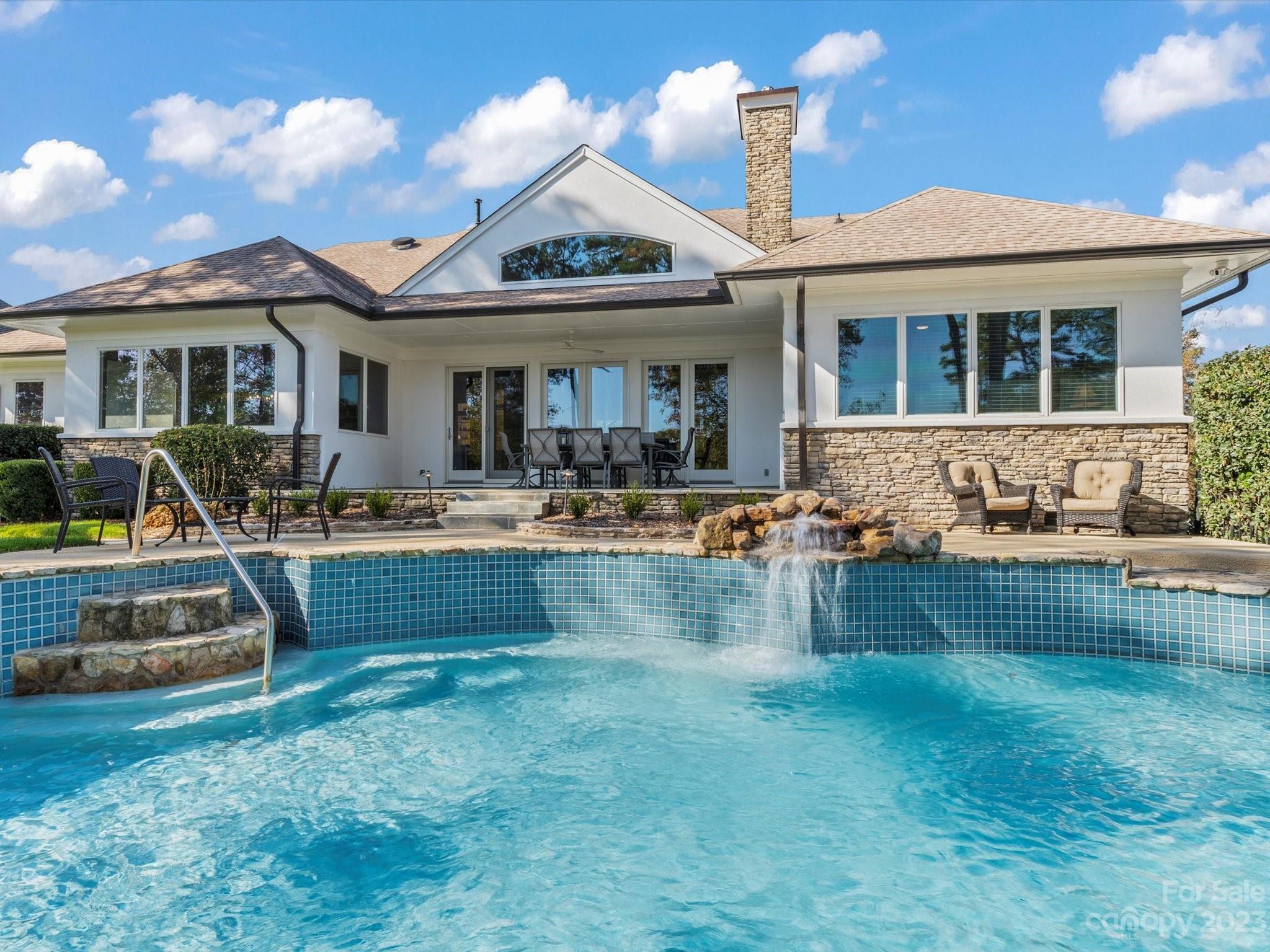 18916 Riverwind Lane Davidson, NC 28036 - Photo 4 of 25 a front view of a house with swimming pool