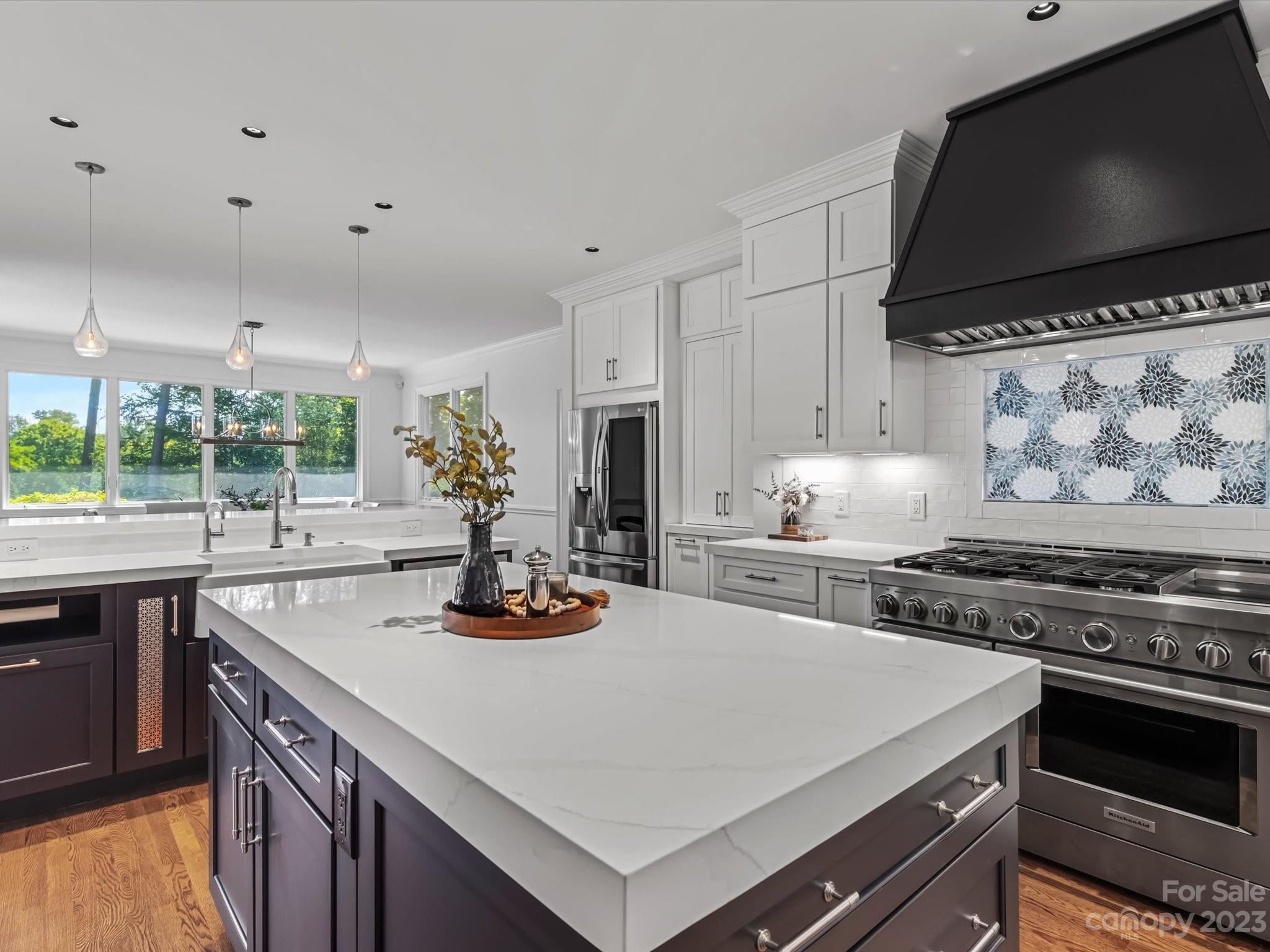 18916 Riverwind Lane Davidson, NC 28036 - Photo 8 of 25 a kitchen with a stove a sink and a microwave