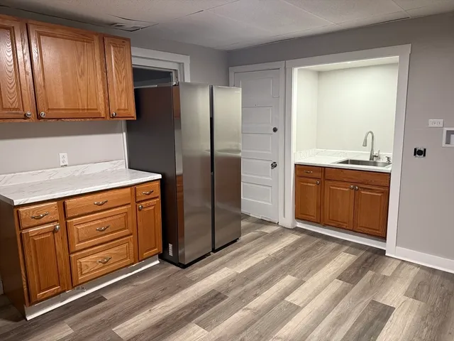 a kitchen with stainless steel appliances granite countertop a refrigerator and a sink