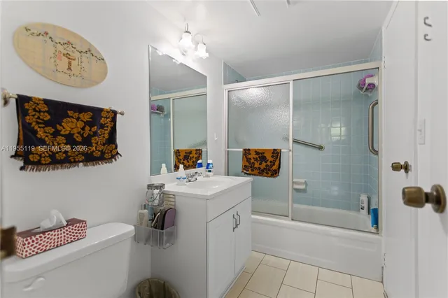 a bathroom with a sink mirror and a shower