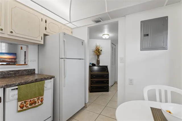 a kitchen with a refrigerator and cabinets